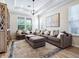 Spacious living room with a large sectional sofa, area rug, and modern chandelier at 5930 Anise Dr, Sarasota, FL 34238
