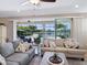 Comfortable living room with neutral tones, ceiling fan, and sliding doors to the screened pool area at 5930 Anise Dr, Sarasota, FL 34238