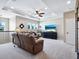 Bright upstairs loft with ceiling fan, neutral carpet, and beach view TV at 5930 Anise Dr, Sarasota, FL 34238