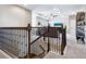 Upstairs loft area with neutral carpet, ceiling fan, and TV at 5930 Anise Dr, Sarasota, FL 34238