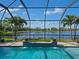 Lake view from pool with water feature and covered lanai at 5930 Anise Dr, Sarasota, FL 34238