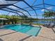Screened-in pool area with brick pavers and a scenic view of the lake at 5930 Anise Dr, Sarasota, FL 34238
