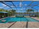 Sparkling pool features a waterfall and views of the lake at 5930 Anise Dr, Sarasota, FL 34238