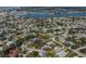 Aerial view of the property highlighting its location near the water, lush greenery, and surrounding neighborhood at 705 Armada N Rd, Venice, FL 34285