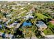 Overhead view of a tranquil neighborhood featuring tree-lined streets and beautiful homes with lush gardens at 705 Armada N Rd, Venice, FL 34285
