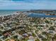 Panoramic aerial view of a coastal home with a pool, near the beach and scenic harbor at 705 Armada N Rd, Venice, FL 34285