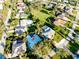 Aerial view of a home with a metal roof nestled in a neighborhood with lush landscaping and mature trees at 705 Armada N Rd, Venice, FL 34285
