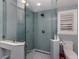 Updated bathroom showcasing a glass enclosed shower, light blue subway tiles, and modern fixtures at 705 Armada N Rd, Venice, FL 34285
