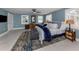 This primary bedroom features a king bed, ceiling fan, plantation shutters, and neutral paint creating a soothing retreat at 705 Armada N Rd, Venice, FL 34285