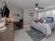 Bedroom with a ceiling fan, a bed with blue-patterned sheets, a desk, and shuttered windows at 705 Armada N Rd, Venice, FL 34285