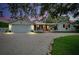Charming home with a two-car garage, manicured landscaping, and a winding driveway at 705 Armada N Rd, Venice, FL 34285