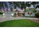 Charming single-story home boasting a brick front patio, white gravel driveway, and lush landscaping at 705 Armada N Rd, Venice, FL 34285