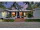 Inviting red brick front porch with seating and beautiful landscaping creates a welcoming entrance at 705 Armada N Rd, Venice, FL 34285