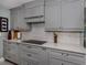 Bright kitchen showcases subway tile backsplash, quartz countertops, and gray shaker cabinets at 705 Armada N Rd, Venice, FL 34285