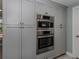 Modern kitchen features stainless steel appliances and gray shaker cabinets at 705 Armada N Rd, Venice, FL 34285