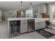 Bright kitchen features gray cabinets, beverage cooler, and farm sink beneath hanging lights at 705 Armada N Rd, Venice, FL 34285