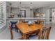 Eat-in kitchen and dining area featuring an island with seating, updated appliances and gray cabinets at 705 Armada N Rd, Venice, FL 34285
