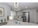 Modern kitchen featuring stainless steel appliances, light gray cabinets, and stone countertops at 705 Armada N Rd, Venice, FL 34285