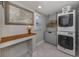 Well-organized laundry room with stacked washer/dryer, countertop and attractive decor at 705 Armada N Rd, Venice, FL 34285