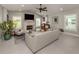 Spacious living room featuring a stone fireplace, plantation shutters, tile flooring, and comfortable seating at 705 Armada N Rd, Venice, FL 34285