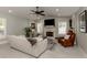 Large living room boasts a stone fireplace, recessed lighting, and shuttered windows at 705 Armada N Rd, Venice, FL 34285