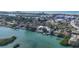 Beautiful aerial view showcasing waterfront homes, lush greenery, canals, and ocean in the background at 107 Louella Ln, Nokomis, FL 34275