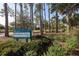 Scenic view of Blackburn Point Park with lush greenery and tall trees surrounding the park sign at 107 Louella Ln, Nokomis, FL 34275