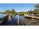Picturesque boat ramp and dock area with clear blue water surrounded by lush green vegetation at 107 Louella Ln, Nokomis, FL 34275