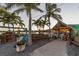 Charming waterfront restaurant with tropical landscaping and inviting outdoor seating at 107 Louella Ln, Nokomis, FL 34275