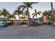 Inviting waterfront restaurant with lush tropical landscaping, outdoor seating, and charming decor at 107 Louella Ln, Nokomis, FL 34275