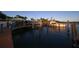 Charming waterfront with outdoor dining, featuring a boat dock, inviting restaurant, and serene water views at 107 Louella Ln, Nokomis, FL 34275