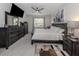 Neutral bedroom with accent wall art, ceiling fan, and natural light at 11601 Parrotfish St, Venice, FL 34292