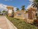 Elegant entry sign of Caribbean Village is surrounded by manicured landscaping and brick accents for a welcoming arrival at 11601 Parrotfish St, Venice, FL 34292