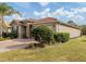 Lovely home featuring a tile roof, paver driveway, and lush landscaping, offering great curb appeal at 11601 Parrotfish St, Venice, FL 34292