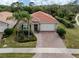 Charming home featuring a tile roof, attached two-car garage, paver driveway, and a well-manicured front yard at 11601 Parrotfish St, Venice, FL 34292