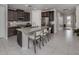 Charming kitchen features granite counters, stainless steel appliances, island with seating, and tile flooring at 11601 Parrotfish St, Venice, FL 34292