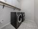 Convenient laundry room equipped with a washer, dryer, storage cabinets, and tiled floors at 11601 Parrotfish St, Venice, FL 34292
