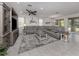 Bright living room features a large sectional sofa, ceiling fan, and neutral decor at 11601 Parrotfish St, Venice, FL 34292