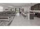 Spacious living room is open to kitchen with granite counters, island seating, and sliding glass door access at 11601 Parrotfish St, Venice, FL 34292