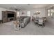 Open concept living and dining area with gray color palette and tile floors at 11601 Parrotfish St, Venice, FL 34292
