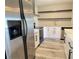 Bright kitchen featuring stainless steel appliances, white cabinetry and granite counters at 1211 Capri Isle Blvd # 123, Venice, FL 34292