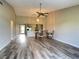 Open-concept living room with hardwood floors and view into the eat-in kitchen at 1211 Capri Isle Blvd # 123, Venice, FL 34292
