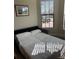 Cozy bedroom featuring a comfortable daybed and natural light streaming through window blinds at 13164 Rinella St, Venice, FL 34293