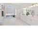Bright bathroom featuring a tub, shower, and double vanity sinks with framed decorative art at 1348 Reserve Dr, Venice, FL 34285