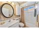 Bathroom featuring a bathtub and shower combo, complete with white tiles and vanity, creating a clean and functional space at 1348 Reserve Dr, Venice, FL 34285