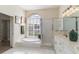 Bright bathroom featuring a tub, shower, and double vanity sinks, tile floors, and natural light at 1348 Reserve Dr, Venice, FL 34285