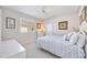 Bedroom featuring plantation shutters, a queen bed, a ceiling fan, and tasteful decor creating a tranquil retreat at 1348 Reserve Dr, Venice, FL 34285