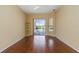 Bedroom featuring hardwood floors, a ceiling fan, and sliding glass doors to screened pool area at 1348 Reserve Dr, Venice, FL 34285