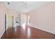 Bedroom featuring hardwood floors, neutral walls, a ceiling fan, and a view to the connected bathroom at 1348 Reserve Dr, Venice, FL 34285