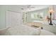 Charming bedroom with twin beds, built-in shelves, and white shutters, creating a cozy and organized retreat at 1348 Reserve Dr, Venice, FL 34285